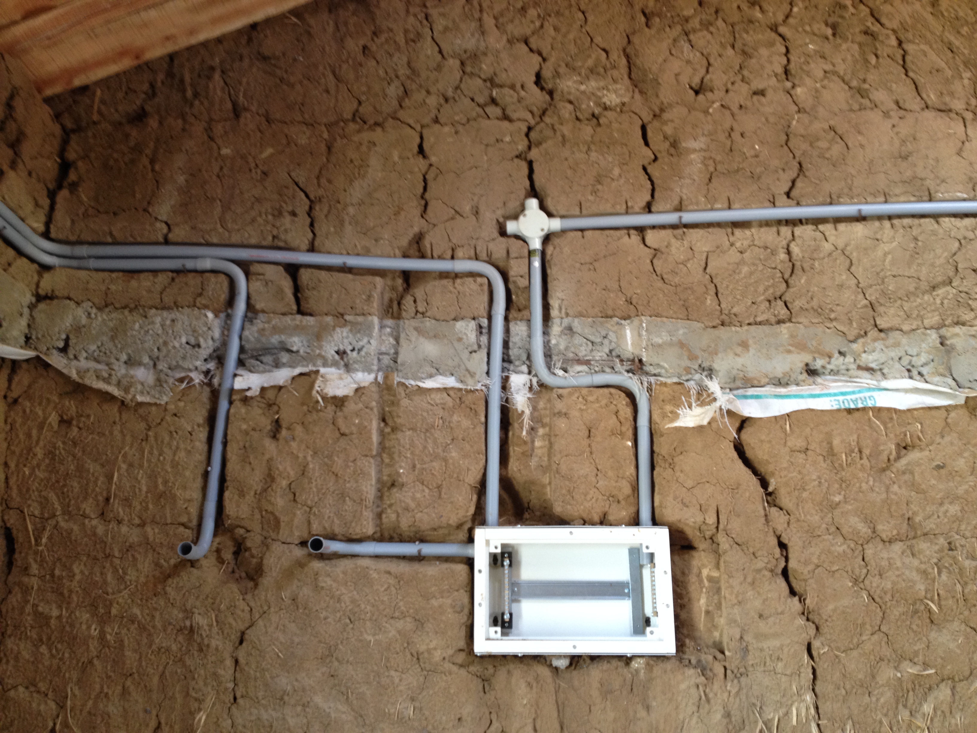 Electrical conduits in mud wall-pre plaster